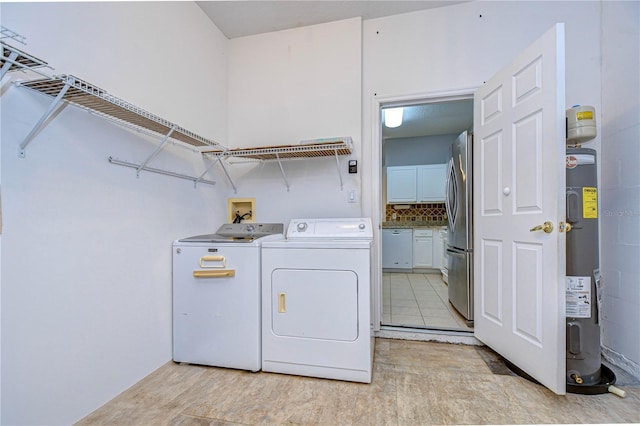 laundry area with water heater and separate washer and dryer