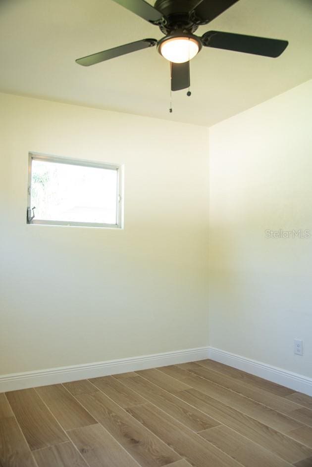 unfurnished room featuring ceiling fan and wood-type flooring