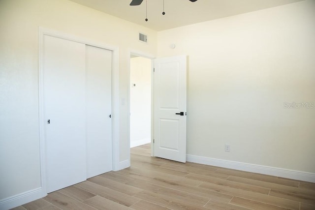 unfurnished bedroom with a closet, ceiling fan, and light hardwood / wood-style flooring