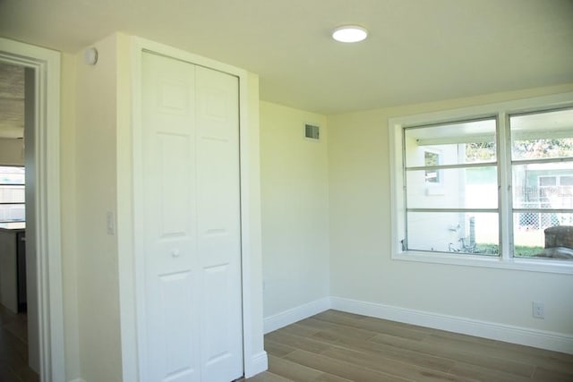 unfurnished bedroom with light hardwood / wood-style floors and a closet