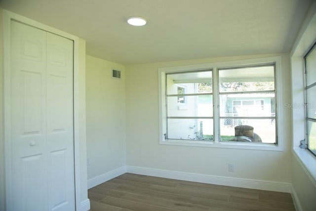 spare room with hardwood / wood-style flooring