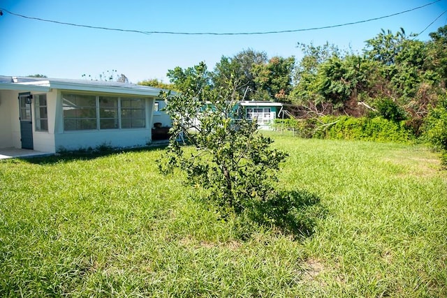 view of yard featuring a sunroom