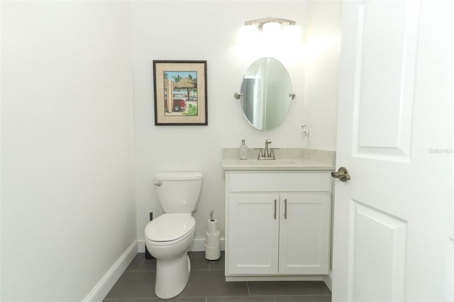 bathroom featuring toilet, vanity, and tile patterned floors