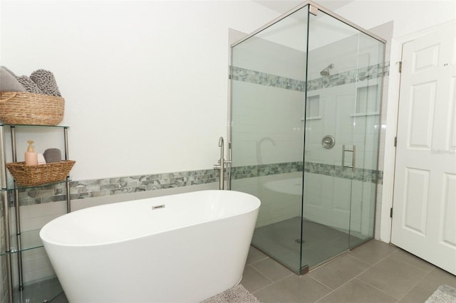 bathroom with tile patterned floors and separate shower and tub