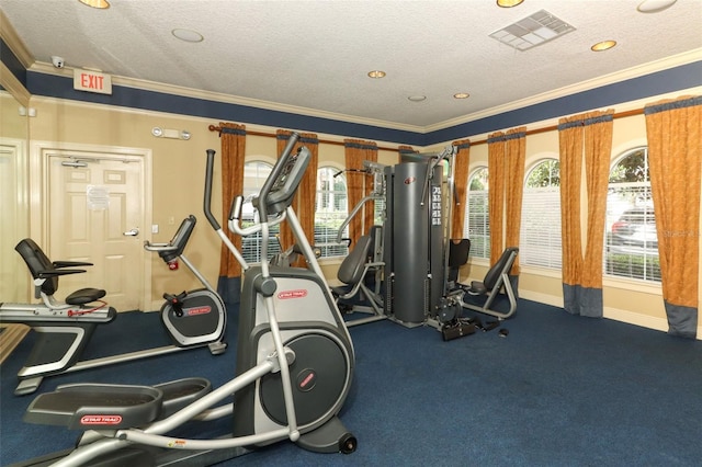 workout area featuring a textured ceiling and crown molding