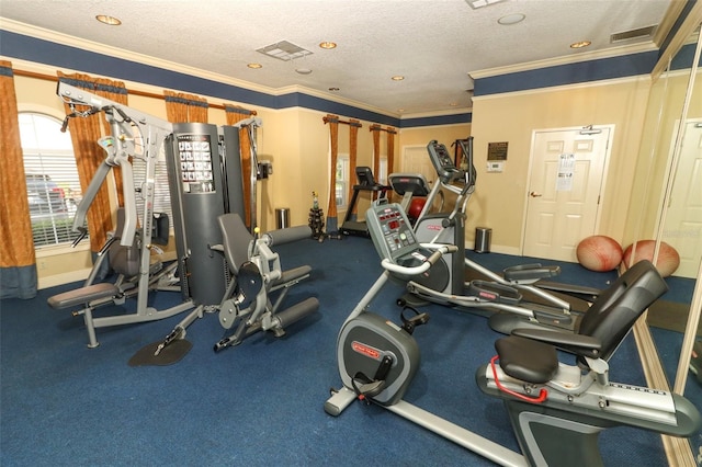 exercise room with a textured ceiling and crown molding