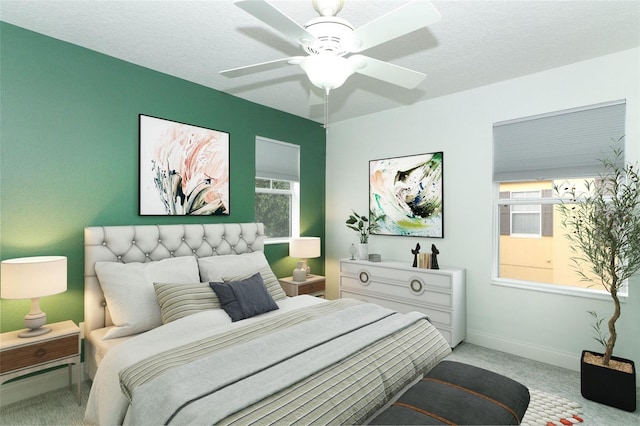 carpeted bedroom with a textured ceiling, ceiling fan, and multiple windows