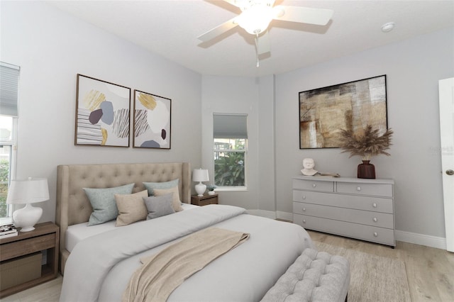 bedroom with ceiling fan and light hardwood / wood-style floors