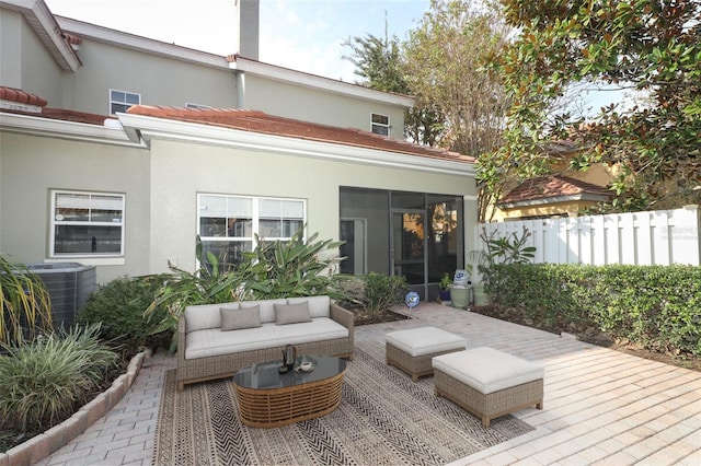 back of property with central AC unit, a patio area, and outdoor lounge area