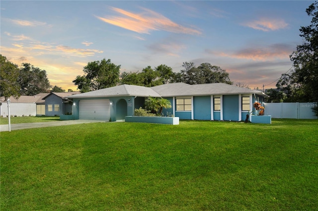 single story home with a yard and a garage