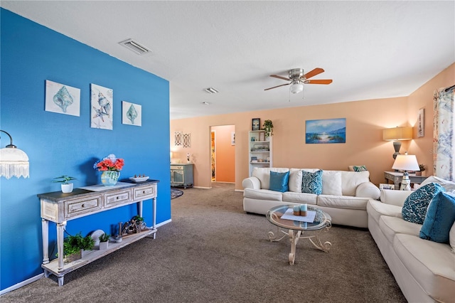 living room featuring dark colored carpet and ceiling fan