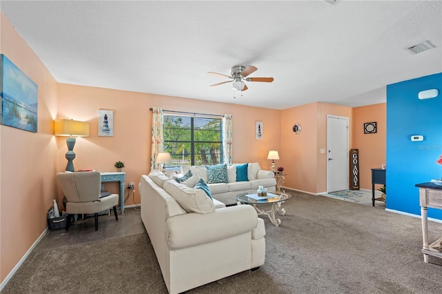 living room featuring ceiling fan and dark colored carpet