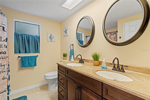 bathroom with vanity, toilet, and tile patterned floors