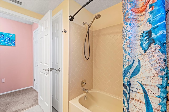 bathroom with shower / bath combination with curtain and a textured ceiling