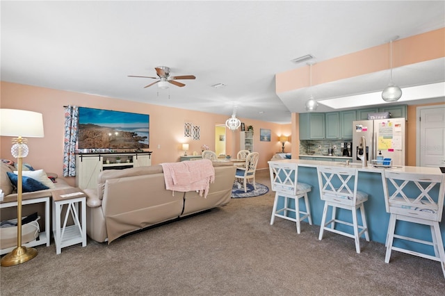 carpeted living room featuring ceiling fan