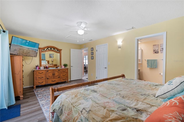 bedroom featuring ceiling fan, a textured ceiling, ensuite bathroom, and hardwood / wood-style floors