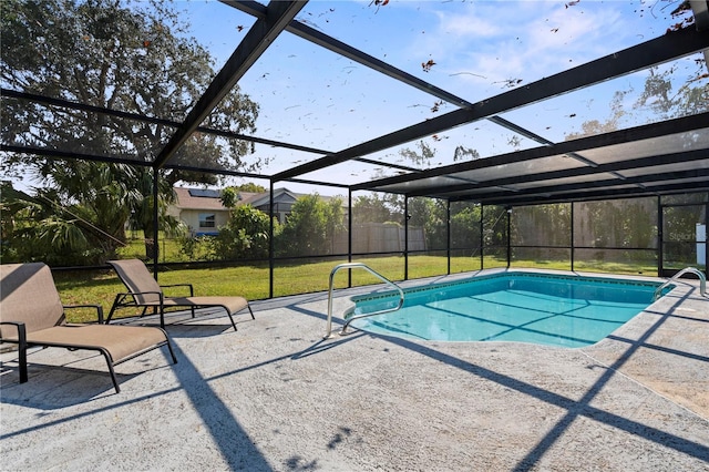 view of swimming pool with a patio, glass enclosure, and a lawn