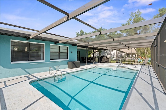 view of swimming pool featuring a patio and glass enclosure