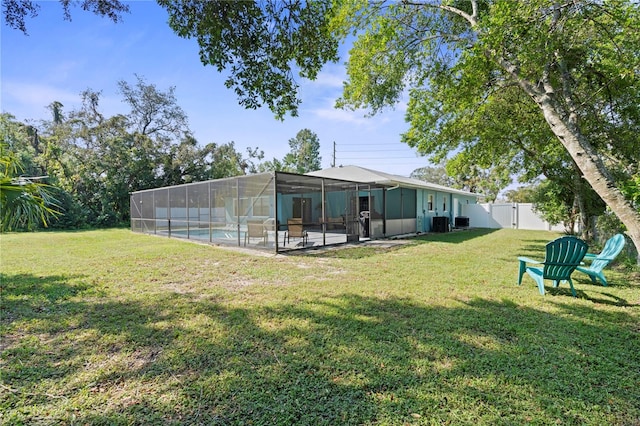 back of house featuring a patio, a lawn, and glass enclosure