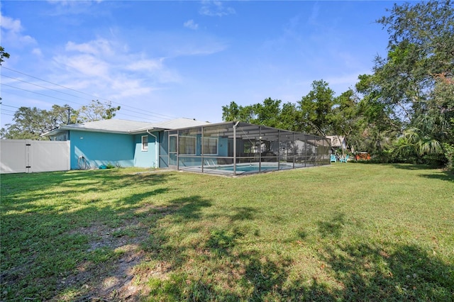 view of yard with a fenced in pool and a lanai