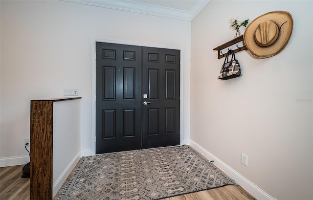 entryway with wood-type flooring and ornamental molding