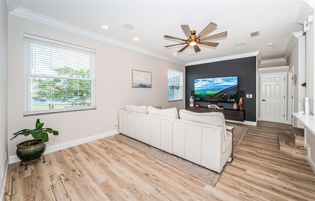 living room with light hardwood / wood-style flooring, ornamental molding, a wealth of natural light, and ceiling fan