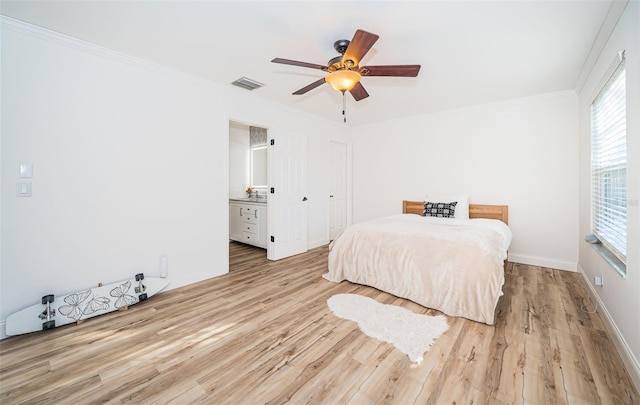 bedroom featuring ensuite bath, ornamental molding, light hardwood / wood-style flooring, and ceiling fan