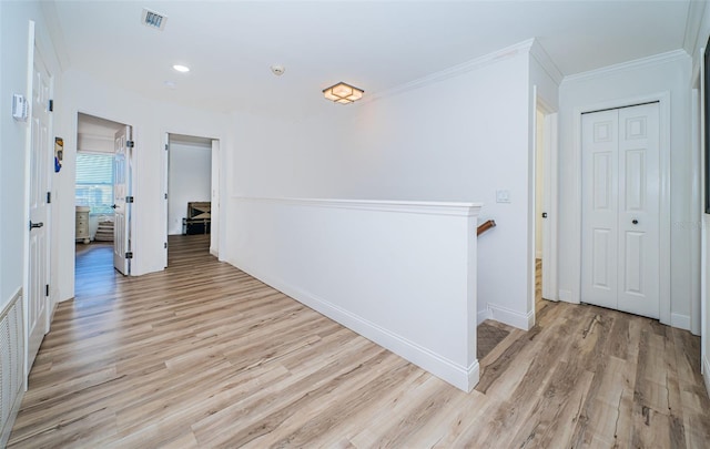 hall featuring crown molding and light wood-type flooring