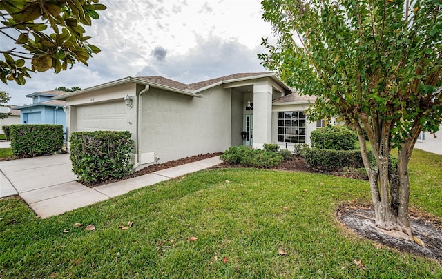 view of front of home with a garage and a front yard