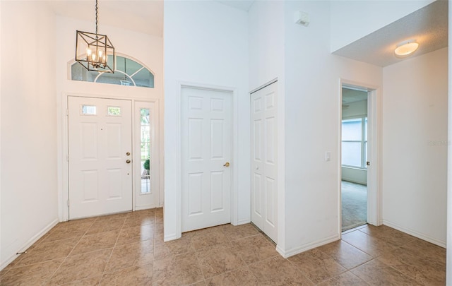 foyer entrance featuring a high ceiling and a chandelier