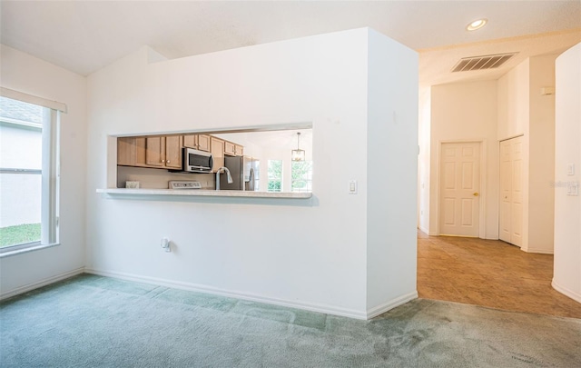 unfurnished living room featuring light colored carpet