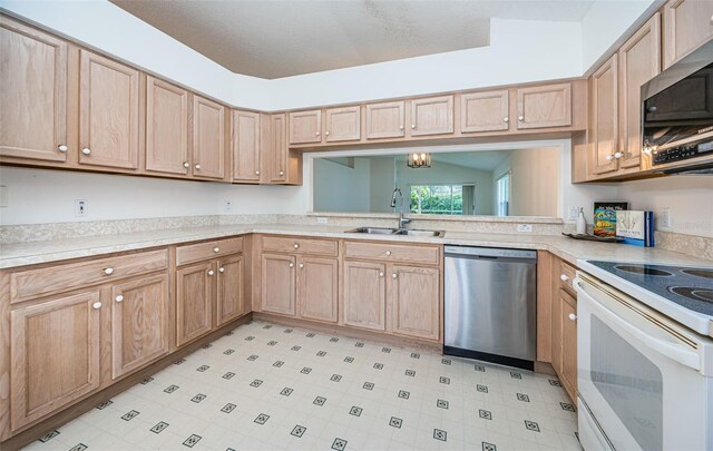 kitchen featuring stainless steel appliances, sink, and light brown cabinets