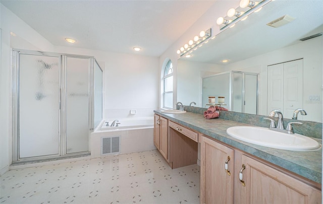 bathroom with vanity and separate shower and tub