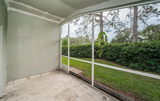 unfurnished sunroom featuring lofted ceiling