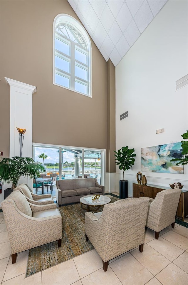 living room featuring light tile patterned flooring and high vaulted ceiling