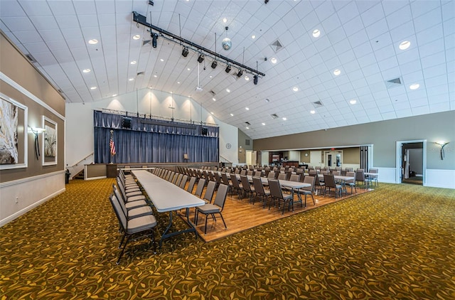 interior space with rail lighting and high vaulted ceiling