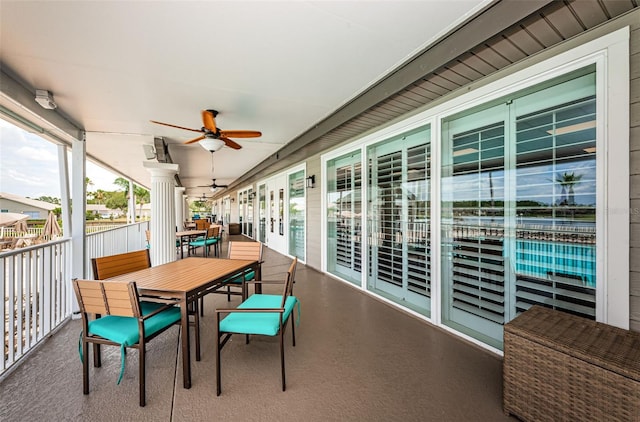 sunroom / solarium featuring ceiling fan