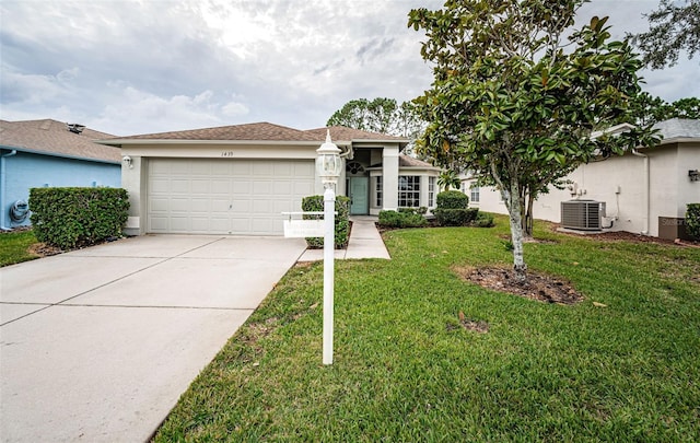 ranch-style house with a garage, central AC, and a front lawn