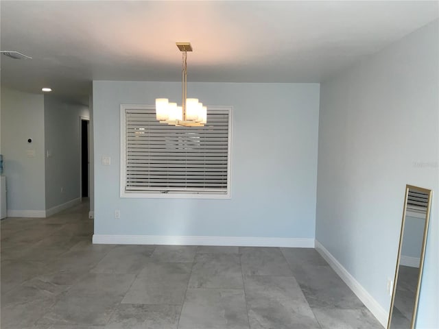 unfurnished dining area featuring a notable chandelier