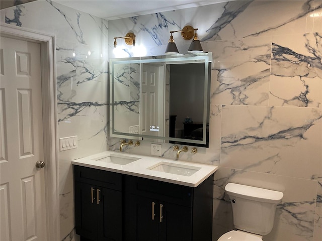 bathroom featuring tile walls, vanity, and toilet