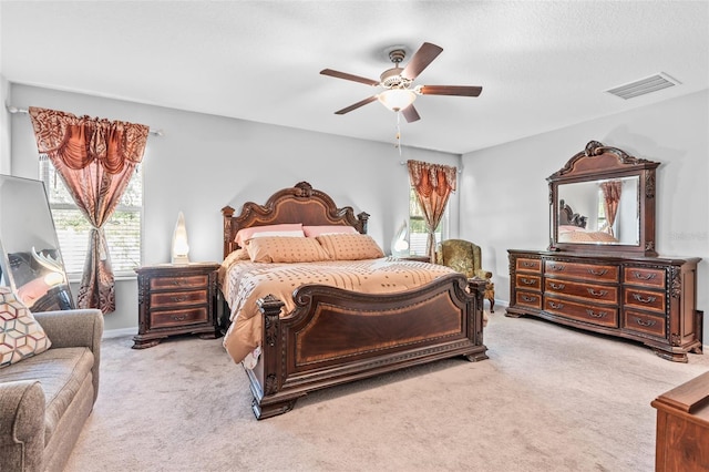 bedroom featuring light carpet and ceiling fan