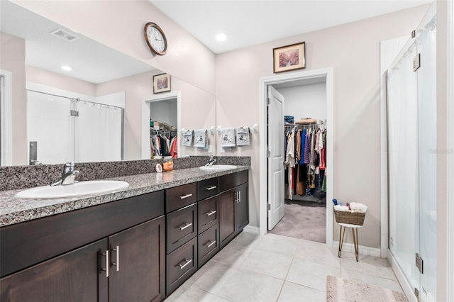 bathroom with vanity, tile patterned floors, and walk in shower
