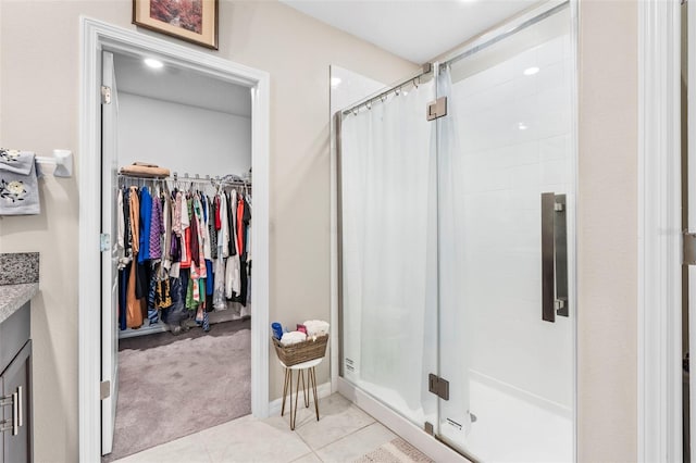 bathroom with vanity, curtained shower, and tile patterned flooring