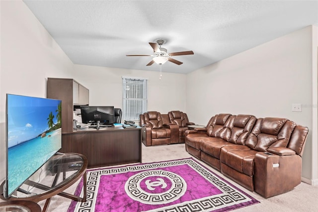 carpeted living room featuring a textured ceiling and ceiling fan