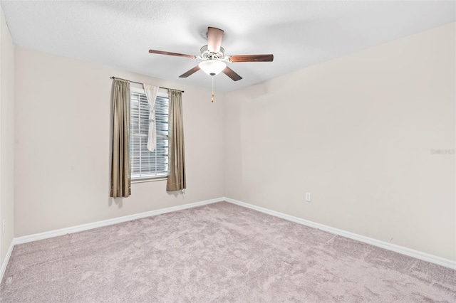 empty room featuring light carpet and ceiling fan