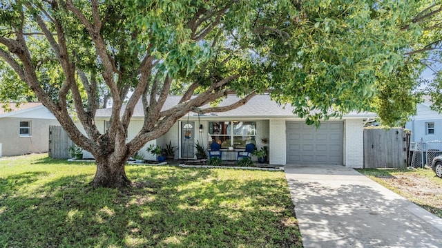 view of front of house featuring a front yard and a garage