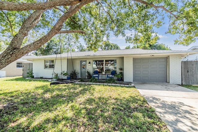 ranch-style home featuring a front lawn and a garage