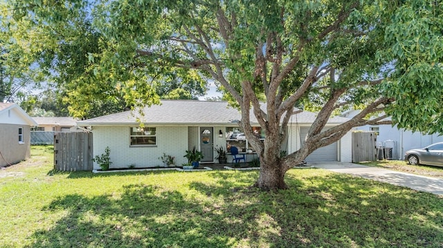 single story home with a front yard and a garage