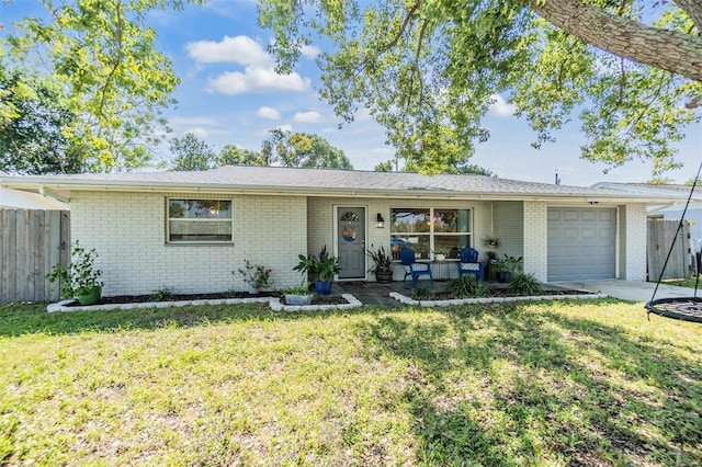 ranch-style home featuring a front lawn and a garage