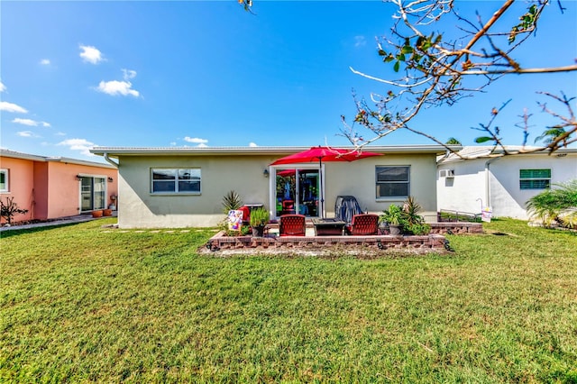 back of property featuring a yard and a patio